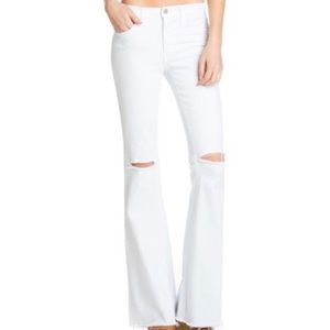 white flared jeans with holes